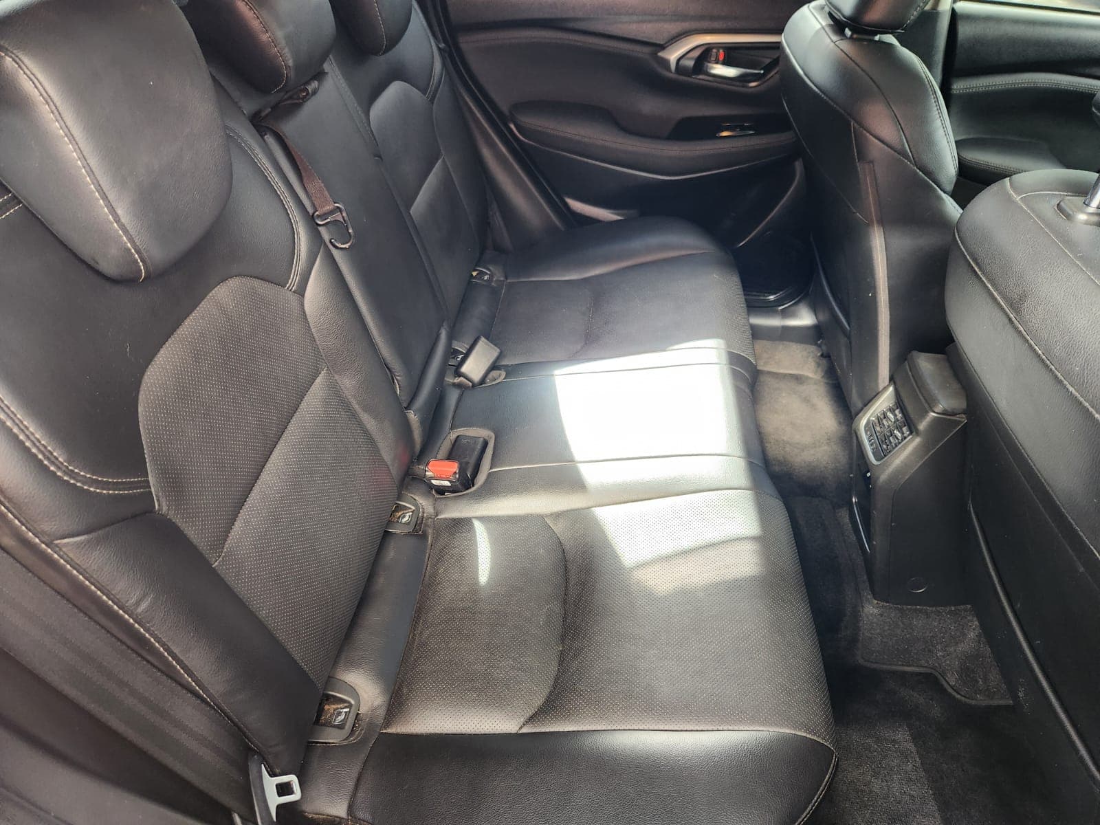 Rear passenger cabin of the 2024 Suzuki Grand Vitara 1.5 GLX Auto, featuring black leather seating.
